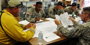 Wildfire water drop planning Florida Army National Guard aviation crew coordinates with Fla. Divison of Forestry before conducting a water drop over wildfires.