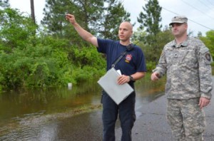 A member of the South Walton Fire Rescue points out flooded areas along a road near Santa Rosa Beach, Fla., to a Soldier from the Florida National Guard's 144th Transportation Company, April 30, 2014. More than 50 Florida Army National Guard Soldiers responded with high-water military vehicles to assist civilian first responders during flooding in Florida's panhandle. (Photo by Master Sgt. Thomas Kielbasa)