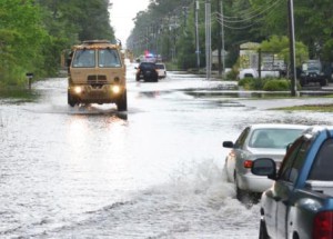 Soldiers in a high-water military vehicle from the Florida National Guard's 144th Transportation Company make their way through flooded roads near Santa Rosa Beach, Fla., April 30, 2014. More than 50 Florida Army National Guard Soldiers responded with high-water military vehicles to assist civilian first responders during flooding in Florida's panhandle. (Photo by Master Sgt. Thomas Kielbasa)