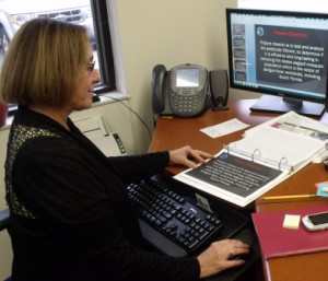 Barbara Golden, prepares and reviews mission essential notebooks and documents for accuracy for a C-130 Aerial Spray Mission at Camp Blanding Joint Training Center.